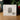 The back of a white jewelry box for 'First Vision' Gem V2 by Angel Johnson, displayed on a wooden surface with a blurred background of greenery and red berries.