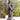 Statue of a Jesus Christ carrying the cross in a natural setting with trees, based on Angela Johnson's work Because of Love, 