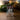 A clear acrylic or glass display block with an etched scene of God the Father and Jesus Christ under bare trees, standing above Joseph Smith on a wooden surface with a softly blurred indoor background.